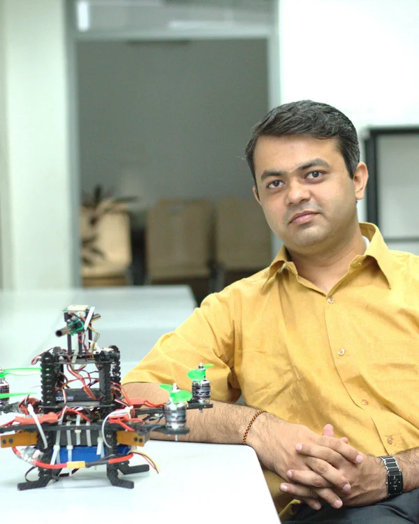 Vishakh Duggal working with a robotics platform in the lab
